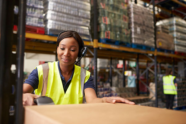 woman packing boxes in warehouse photo