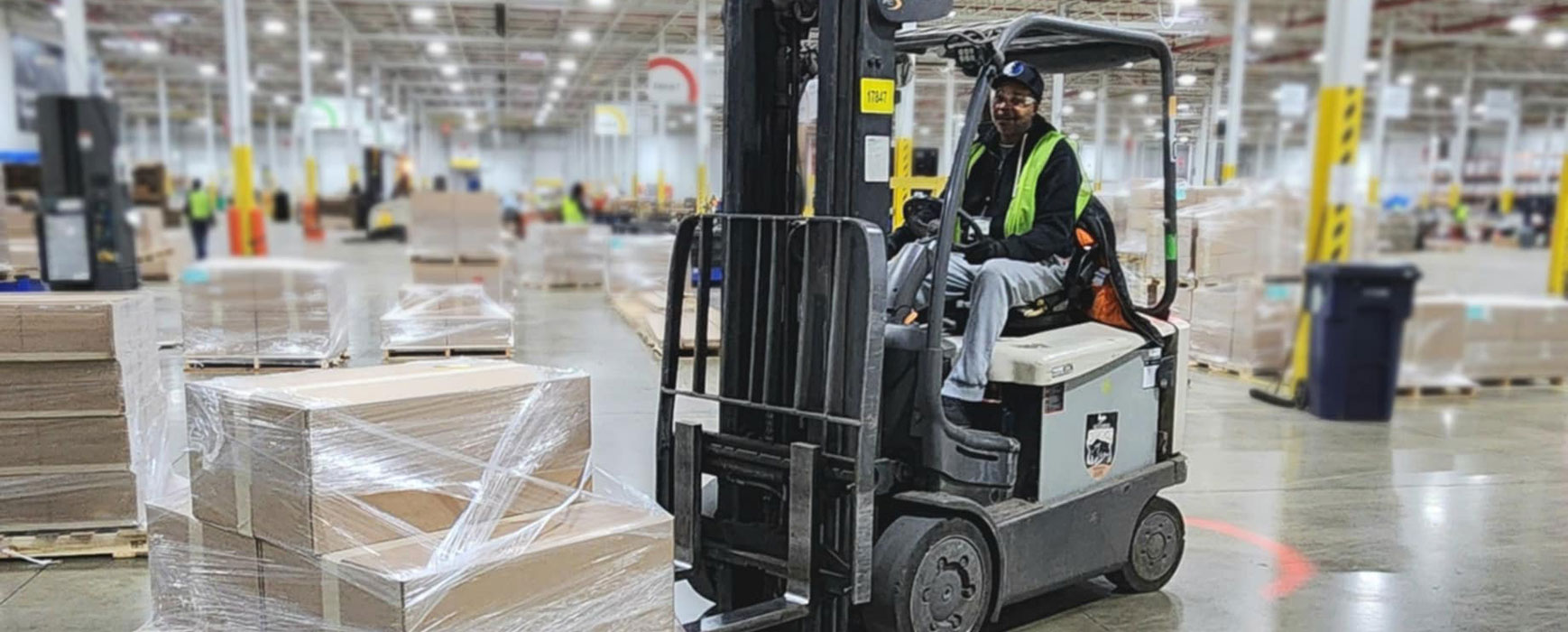 man driving forklift in warehouse photo