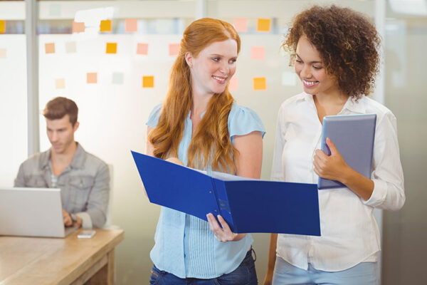 women reviewing documents in office photo