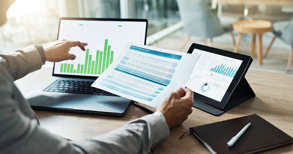 person comparing data with screen photo