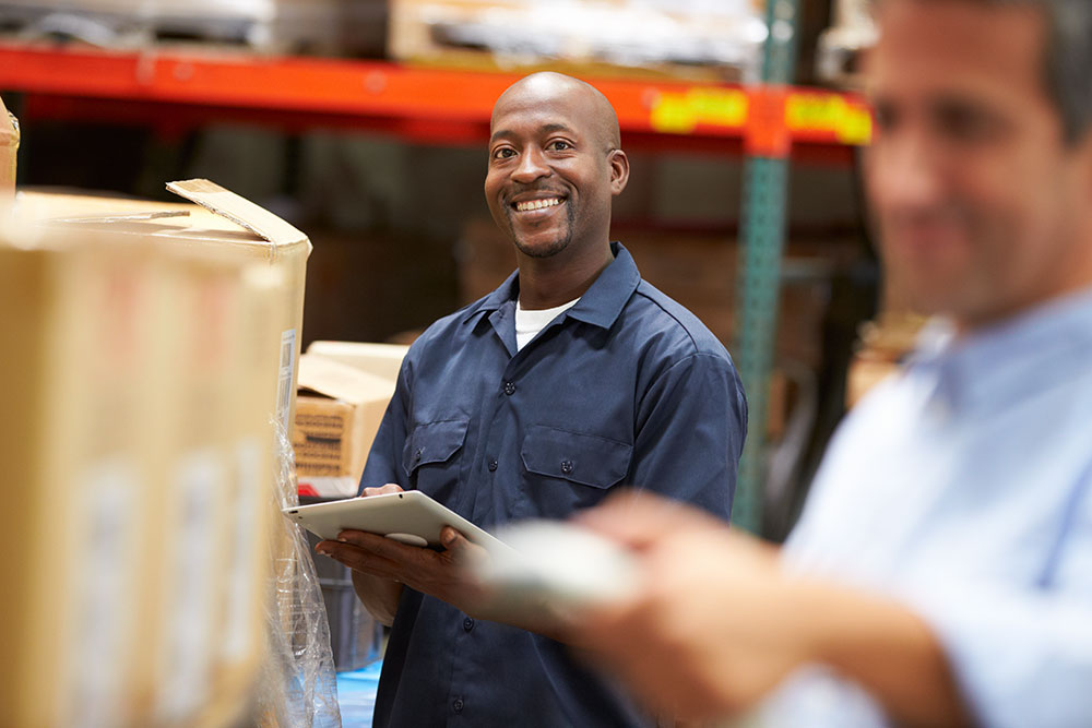 man with clipboard on warehouse floor photo