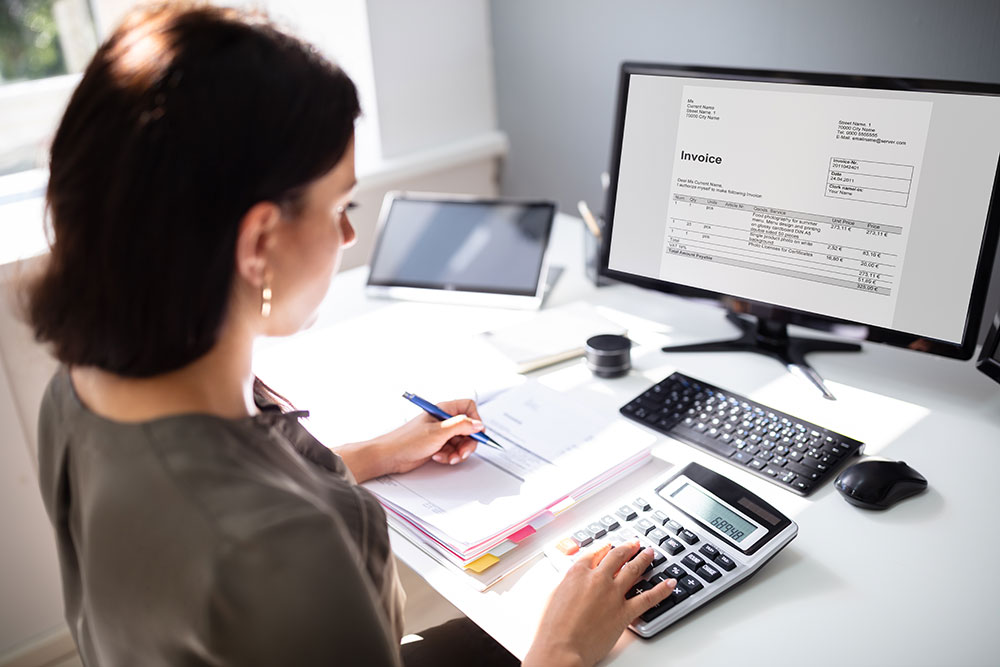 woman filing tax info at computer photo